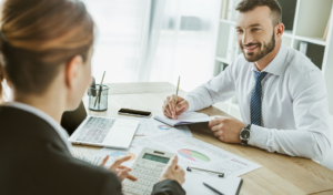 Accountant meeting with a client to discuss financial information, highlighting communication skills and client readiness in accountancy.